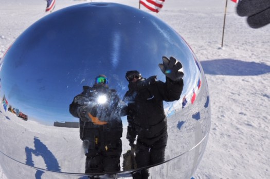 Us reflected in the ceremonial pole with 12 flag around