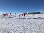 The Ceremonial South Pole with 12 flags with the residence hall&nbsp;behind.