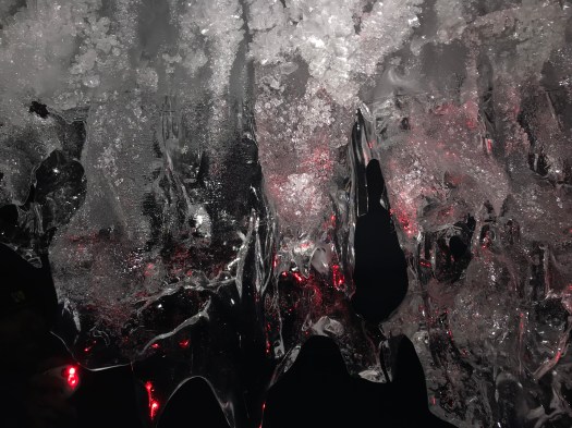 More clear crystal under red light.