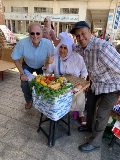 A food vendor hamming it up Sith Mark and another customer