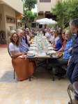 18 of us enjoy an outdoor lunch of couscous tajine, standard fair for Fridays in&nbsp;Morocco.