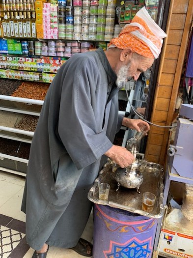 The vendor makes tea after we buy some spice.