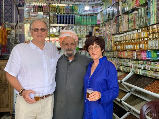We share tea with the vendor in his shop.