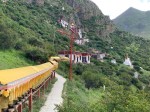 A path of prayer wheels leading to another cluster of&nbsp;caves.