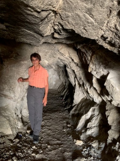Standing inside an abandoned ruby mine. looking for red rocks.