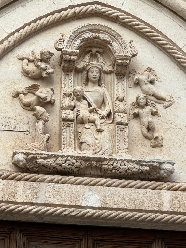 The man kneeling next to the virgin is the founder of the church.